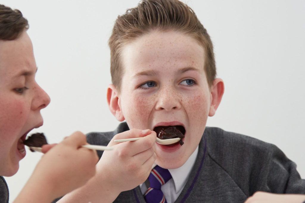A colour image of school pupils eating.