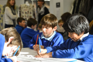 A colour image of school pupils working.