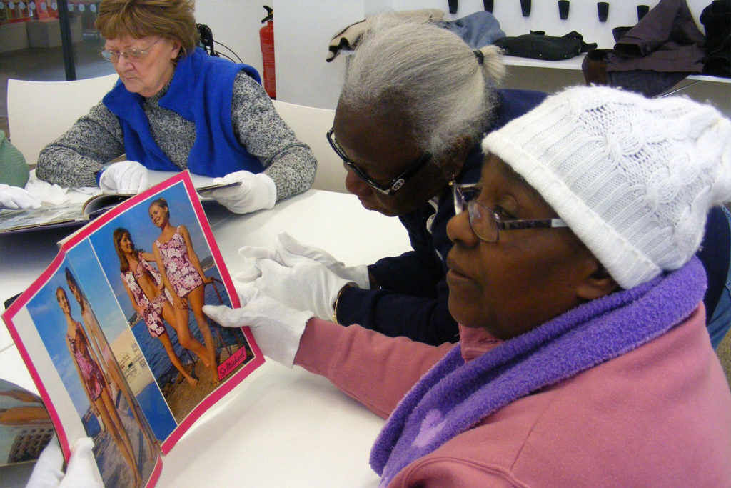 A colour image of women looking at archives.
