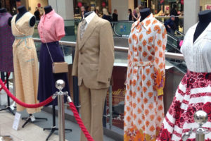 A colour image of mannequins in vintage outfits.