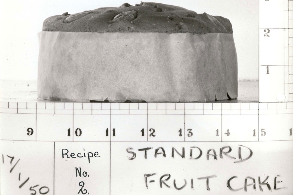 A black and white image of a fruit cake with measurements.