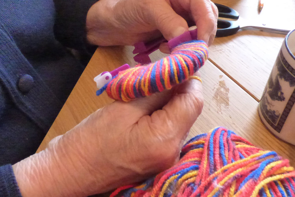 colour image of someone making a pompom
