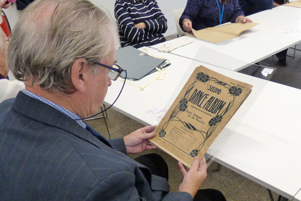 A colour image of a visitor looking at an archive document