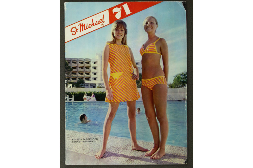 Colour image of a magazine cover showing two models in swimwear