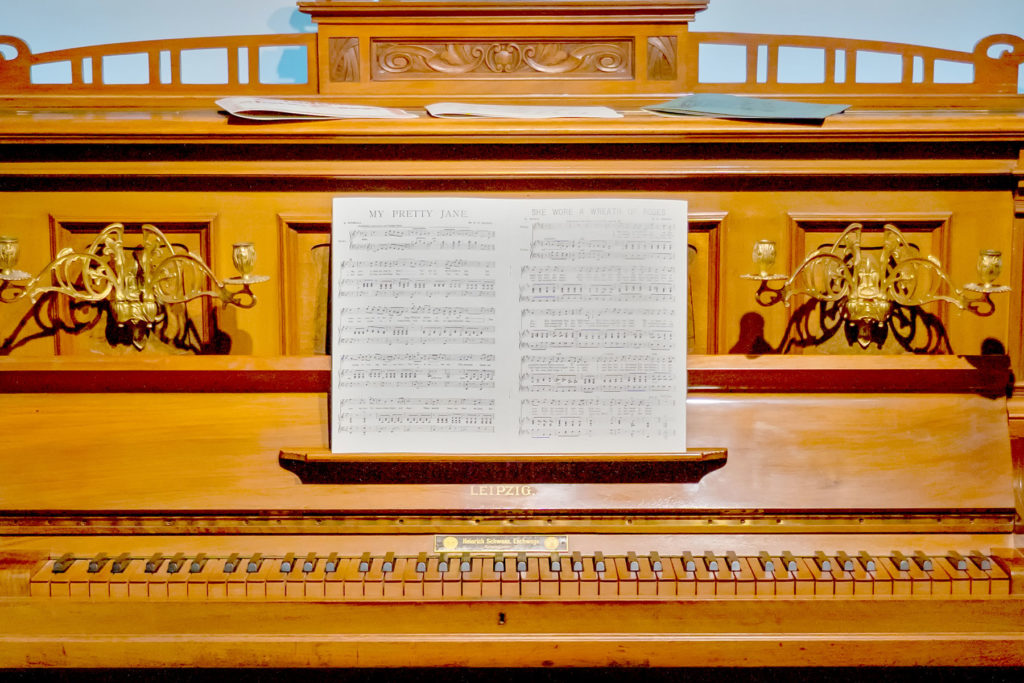 Colour image of a piano with music open on the stand