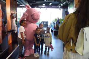 Colour image of a group of children having their photo taken with Percy Pig