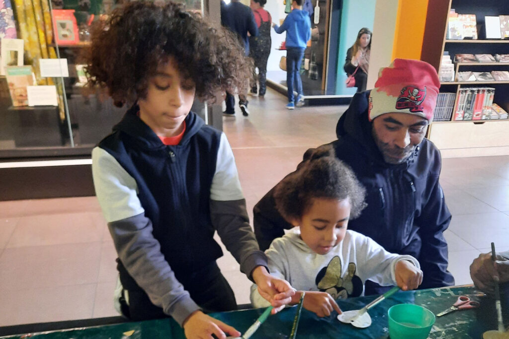 A colour image of a family doing a craft activity