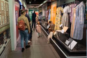 Colour photo showing a museum exhibition with visitors