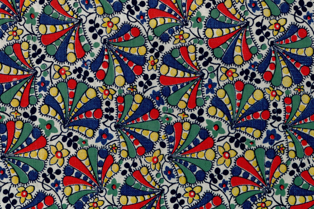 Colour image of a fabric print with red, blue and yellow design