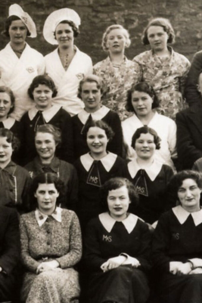 A black and white image of people in a group photo