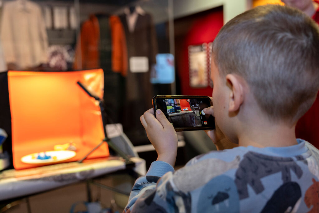 Colour photo of a child taking a photo