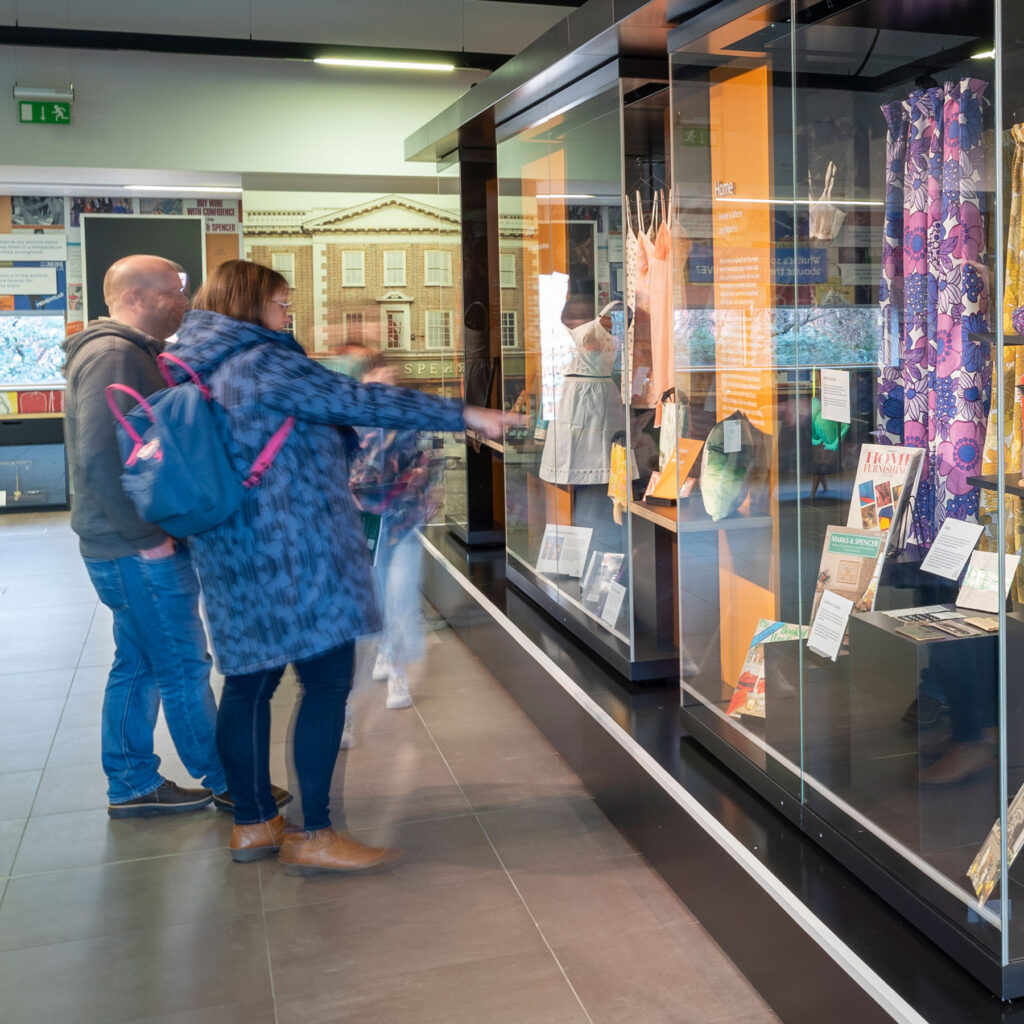 Colour image of people looking at museum displays